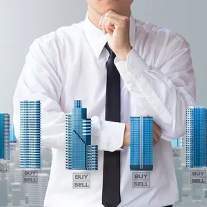 Man with hand under chin in background with computer generated images of buildings in foreground.